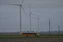 A school bus drives down a road near a field of wind turbines, Thursday, May 9, 2024, in Paxton, Il…