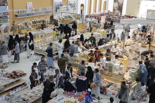 People shop in a supermarket in Sanaa, Yemen, before the Eid holiday on Saturday, June 15, 2024