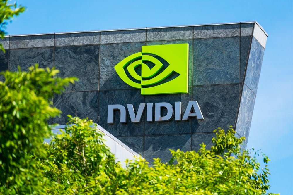 Nvidia logo and sign on headquarters. Blurred foreground with green trees - Santa Clara, California, USA - 2020