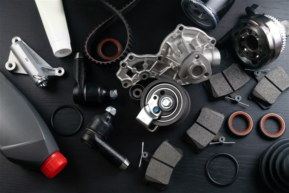 collection of auto parts on black background