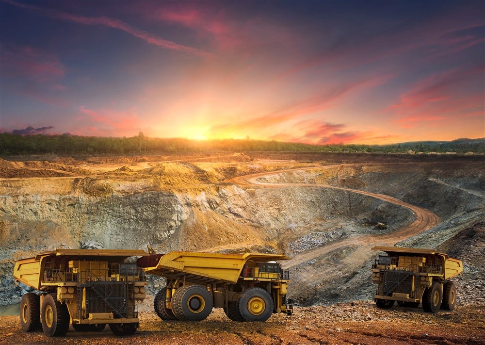 image of dump trucks transporting gold at gold mine