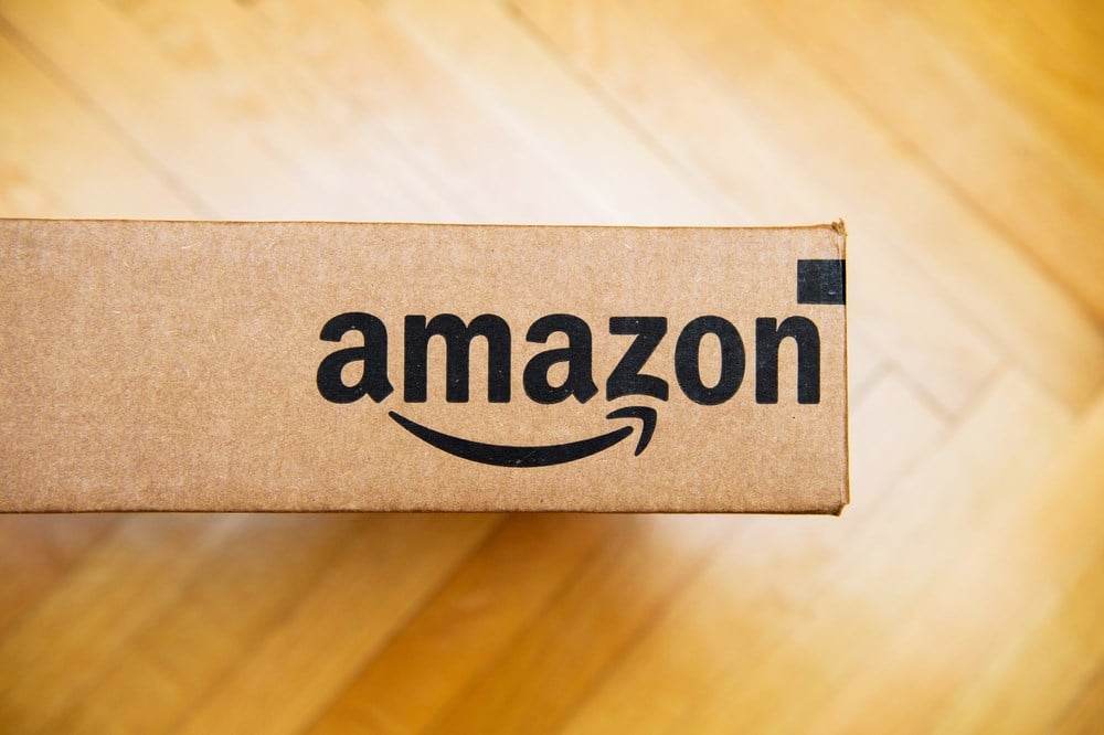 Amazon logotype  on cardboard box side; learn more about Amazon reversal