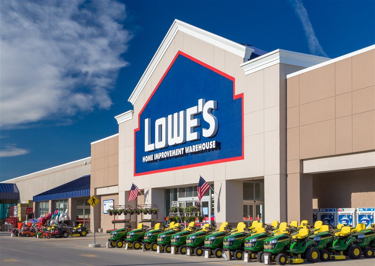 Lowe's store front with row of green lawnmowers
