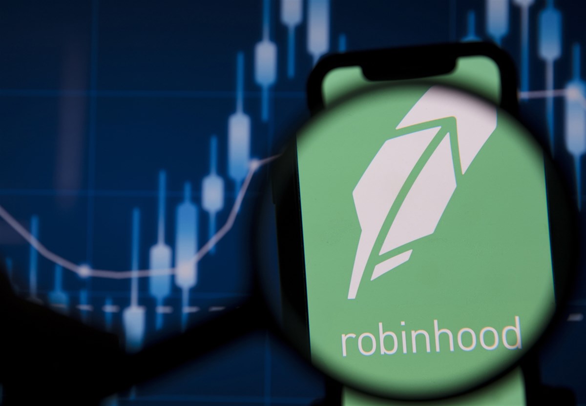 Robinhood investing app under magnifying glass.