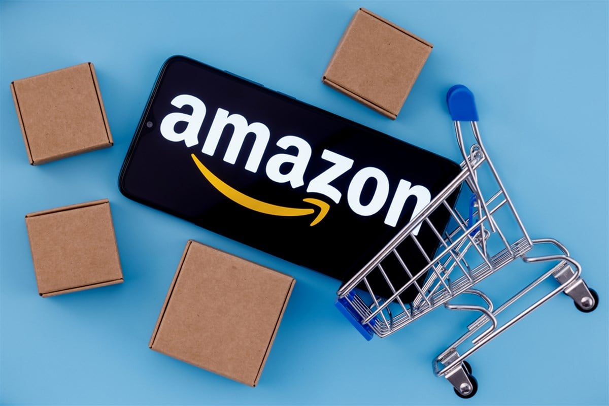 Amazon logo on smartphone screen shopping carts and boxes