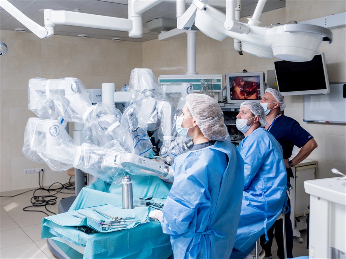 surgical robot in operating room with surgeons