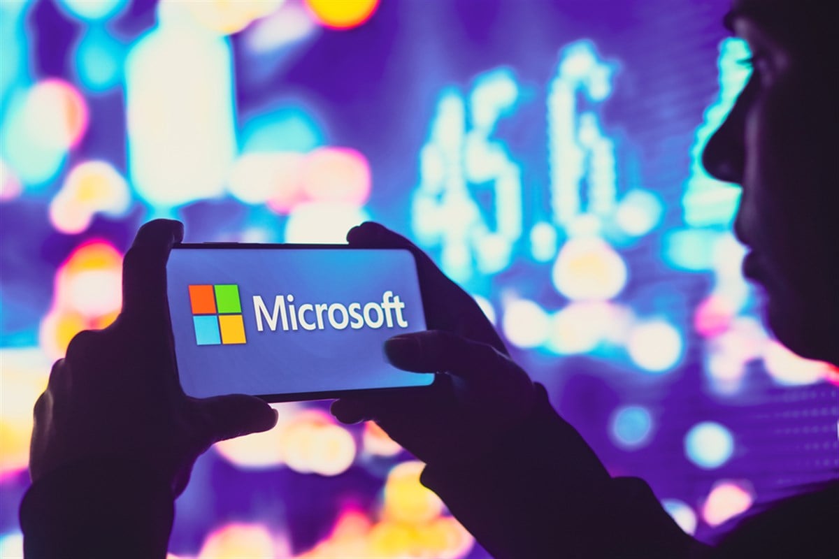 June 1, 2022, Brazil. In this photo illustration, a silhouetted woman holds a smartphone with the Microsoft Corporation logo displayed on the screen