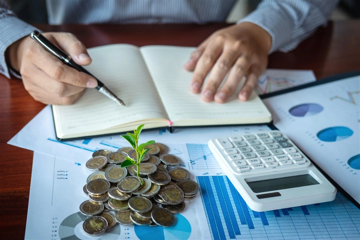 Businessman accountant making notes at report doing finances and - stock image