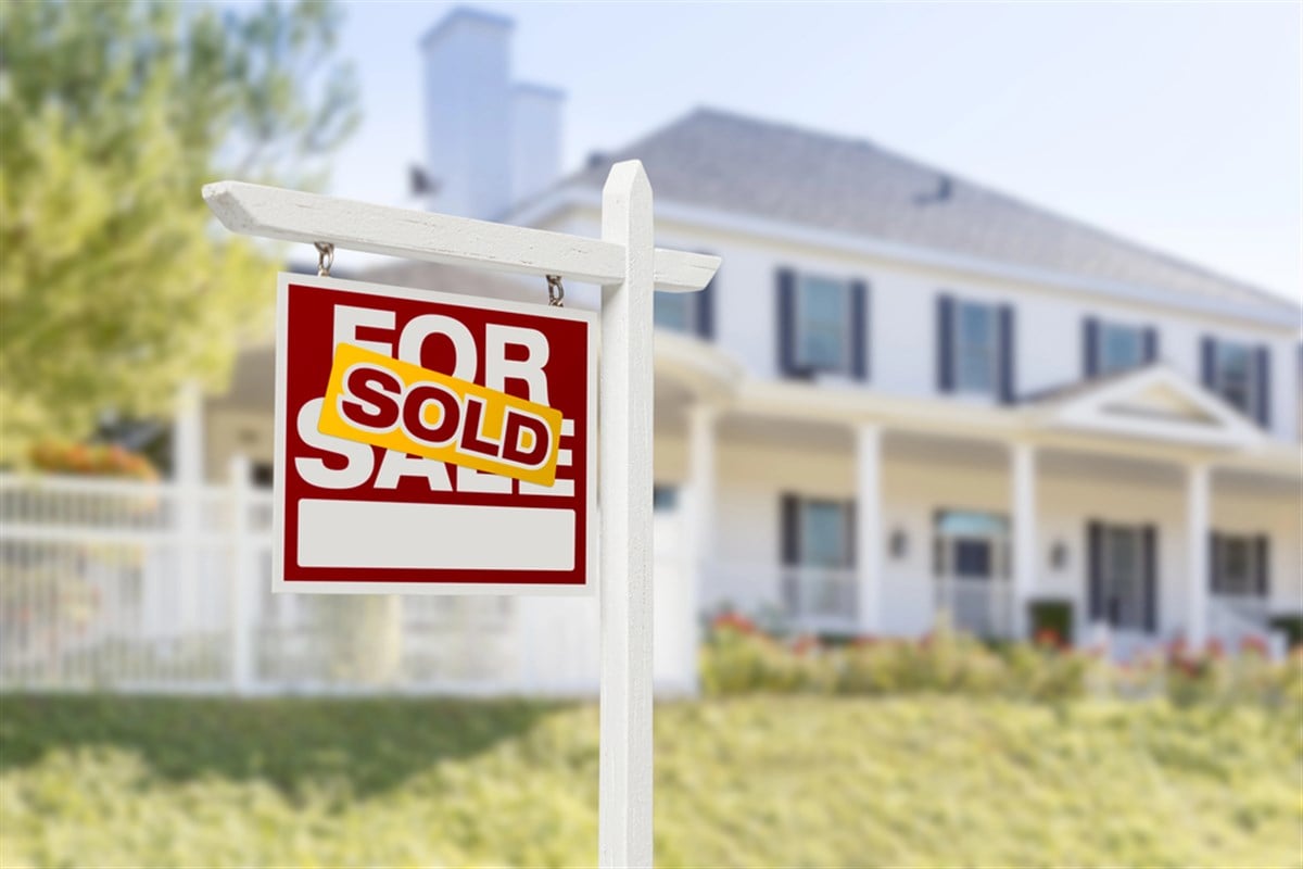 Sold Home For Sale Sign in Front of New House - stock image