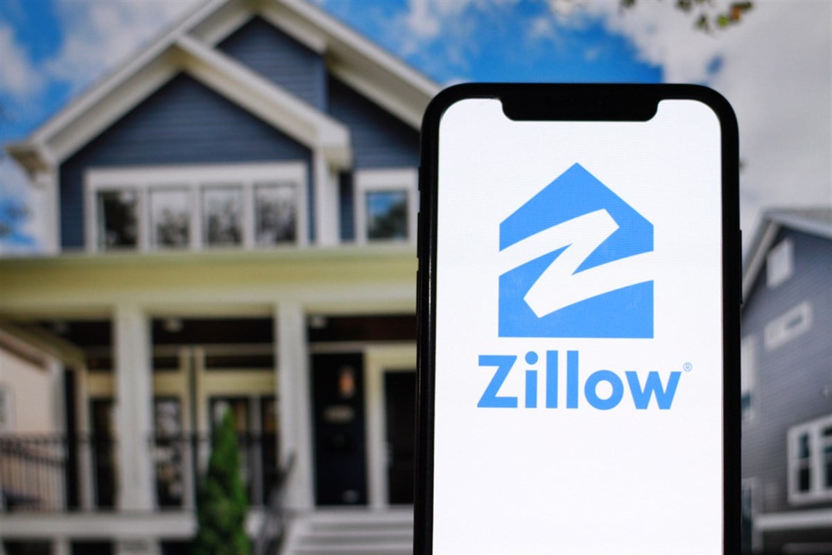 Zillow logo on phone with house background