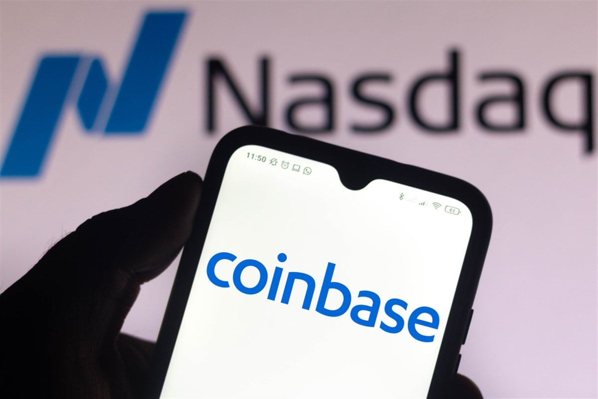 photo illustration the Coinbase logo seen displayed on a smartphone screen with the logo of Nasdaq in the background