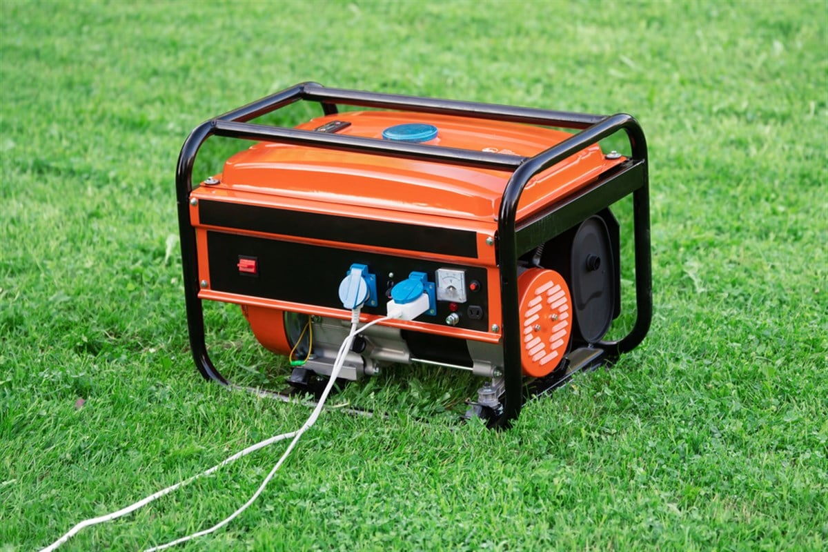 Portable electric generator on the green grass outdoors — Photo