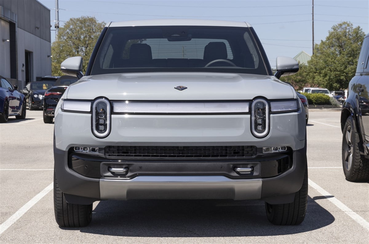 Rivian R1T Pickup Truck display at a dealership. Rivian offers the R1T in Explore, Adventure and Launch models.