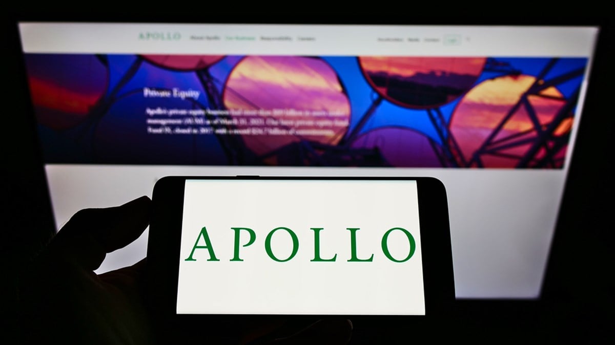 STUTTGA, GERMANY - Jun 20, 2021: Person holding cellphone with logo of American investment company Apollo Global Management Inc on screen in front of website. Focus on phone display. - Stock Editorial Photography