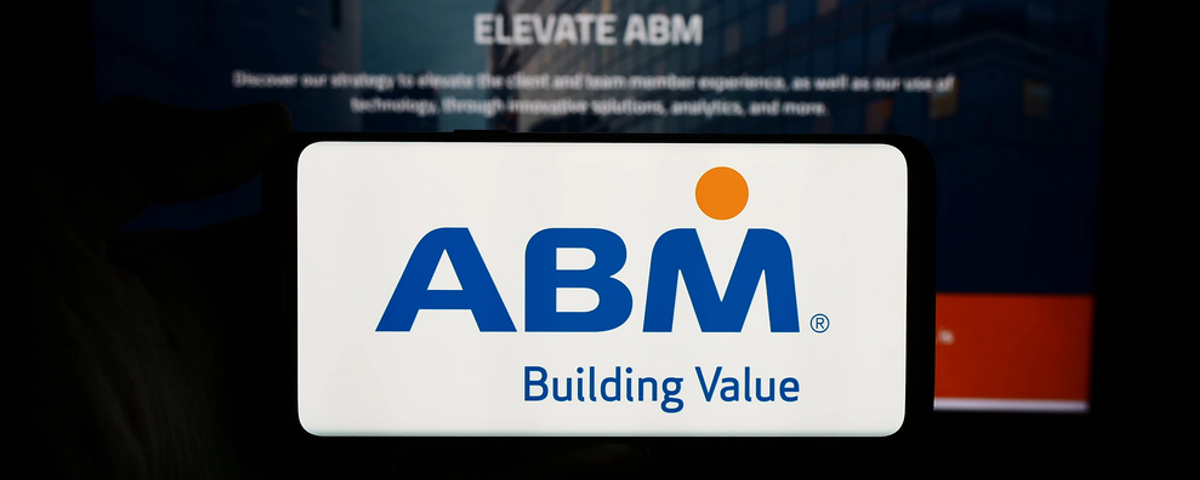 Stuttgart, Germany - 03-13-2024: Person holding cellphone with logo of US facility management company ABM Industries Inc. in front of business webpage. Focus on phone display. — Stock Editorial Photography