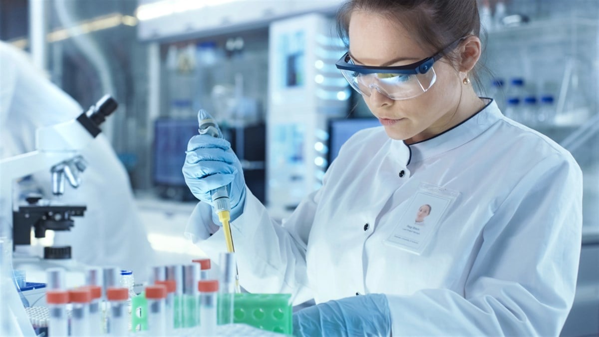 Female Research Scientist Uses Micropipette Filling Test Tubes i - stock image