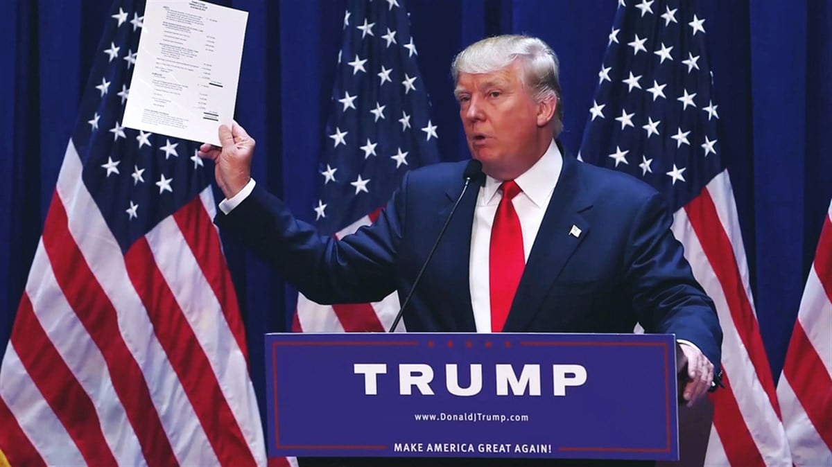 Washington, DC / USA - June 16, 2015: Donald Trump's Presidential Announcement Speech, holding and showing paper documents evidence to the press. - Stock Editorial Photography