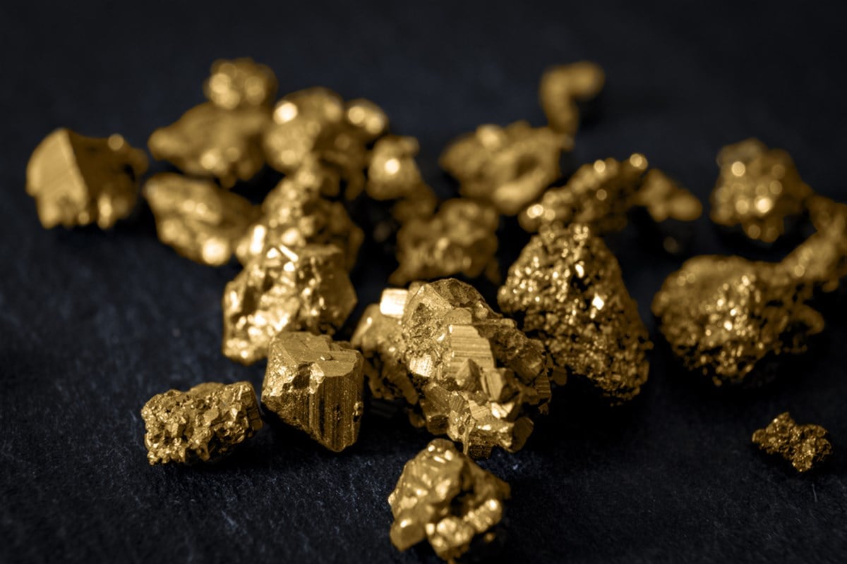 Gold mining and and investment in precious metals concept with close up on golden nuggets on a black background