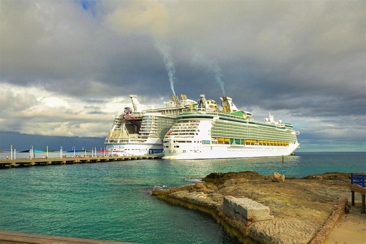 Two Luxury cruise ships of Royal Caribbean docked on port in Bahamas Image background | Two huge luxury cruise ships docked on port in Caribbean sea | Cruising, Vacation, Caribbeans, Tropical, luxury, travel, tourism concept image - Stock Editorial Photography