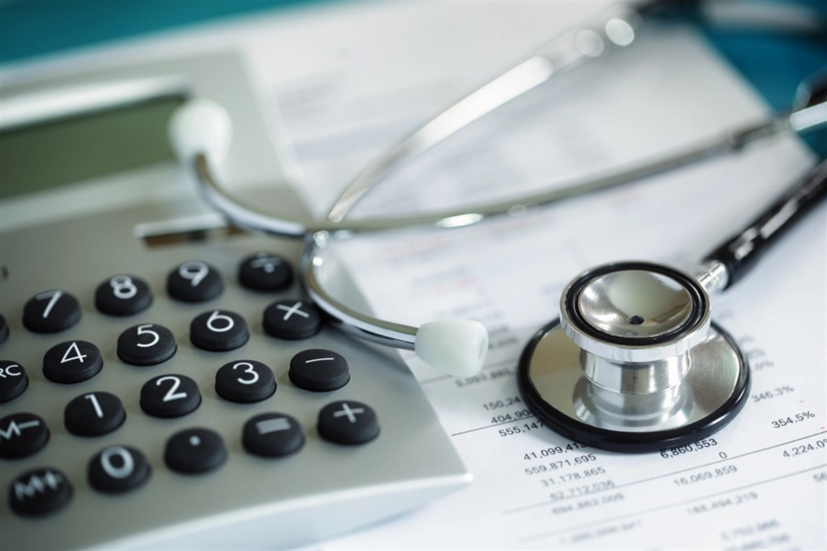 Photo of financial information with a stethoscope on top.