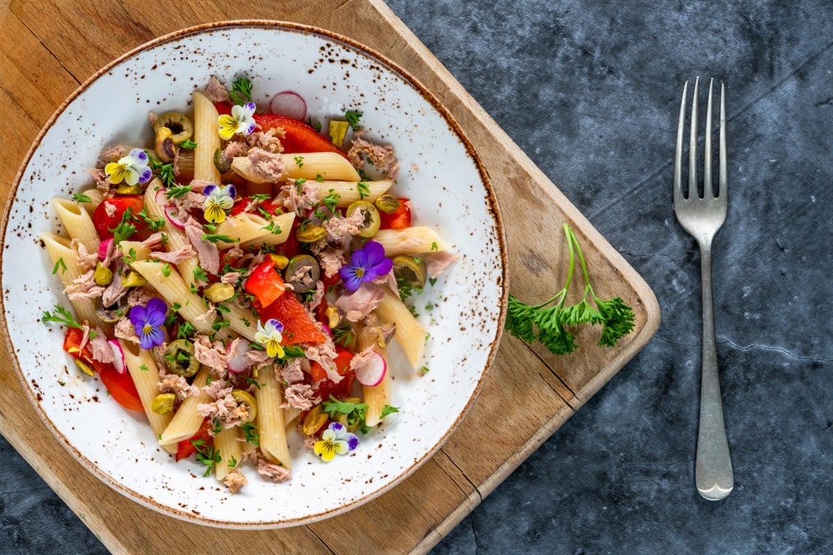 Warm tuna and roasted pepper pasta salad with pistachio nuts - overhead view