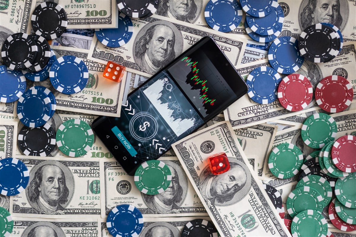 Money and smartphone with sports bet application. High quality photo - stock image