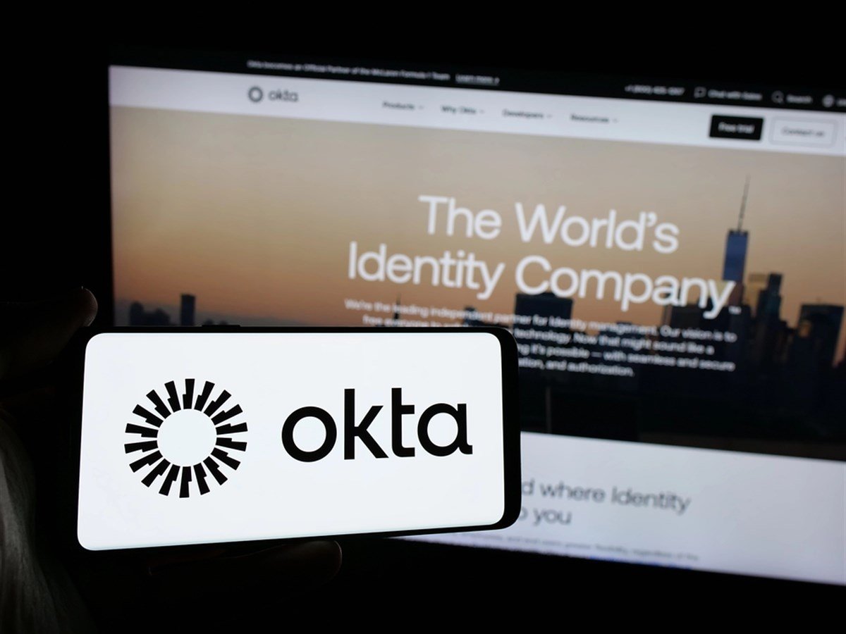 Stuttgart, Germany - 01-29-2025: Person holding smartphone with logo of US identity management company Okta Inc. on screen in front of website. Focus on phone display. — Stock Editorial Photography