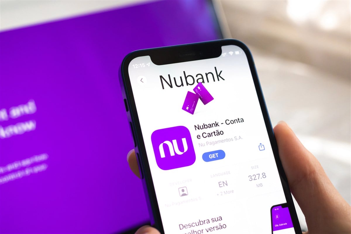 Poltava, Ukraine - April 5, 2022: Nubank app icon. Hand with mobile phone with application. Mobile banking concept - Stock Editorial Photography