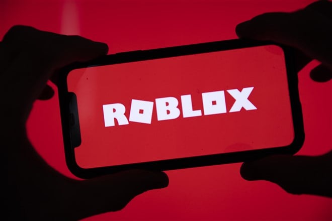 illustration of roblox logo on mobile device on red background