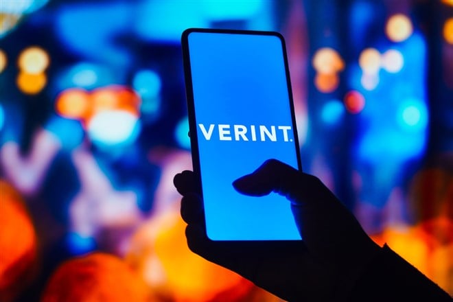 Verint Systems logo is displayed on a smartphone screen