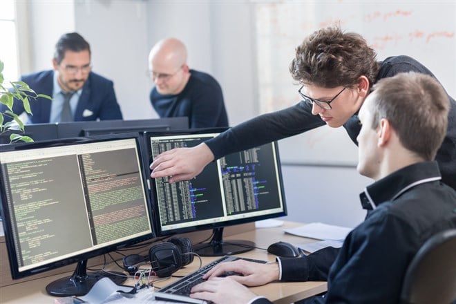 software developers working on desktop computer