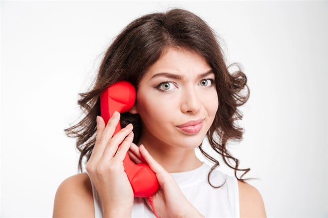 Photo of a woman using her hand to cover a red phone. How to Optimize Your Covered Call Strategy in a Rising Market.