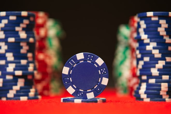 Photo of poker chips, with a blue one in front, symbolizing blue chip stocks.