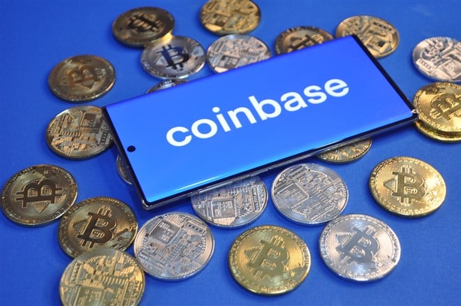 Coinbase app with gold bitcoin coins on smartphone