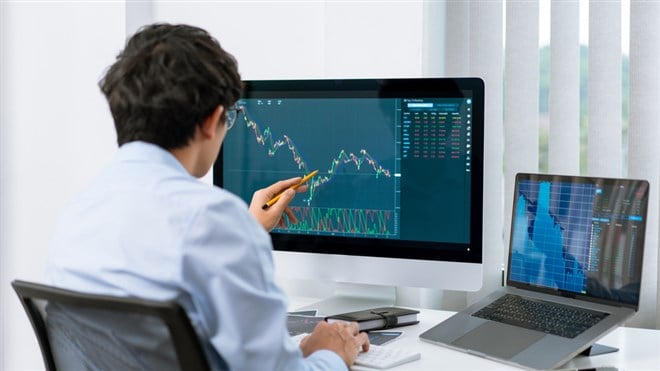 Financial concept a businessman studying the stock chart analyzing the growths of the stock from the chart before investment