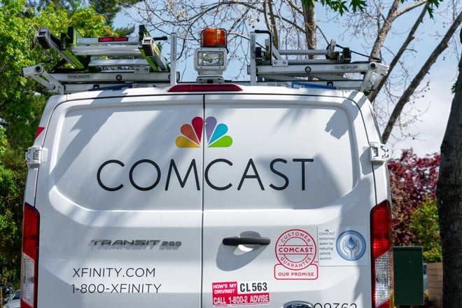 Comcast Xfinity telecommunications service van parked on the residential street near the customer home