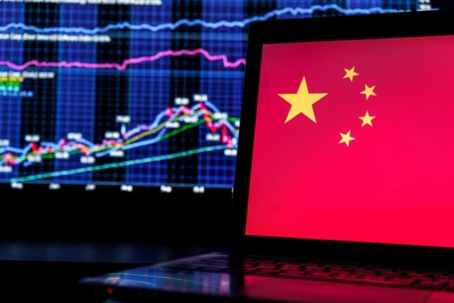 China flag on screen and stocks and finance graphs in background