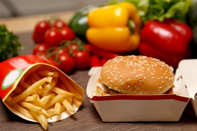 BigMac and french fries on a healthy background — Stock Editorial Photography