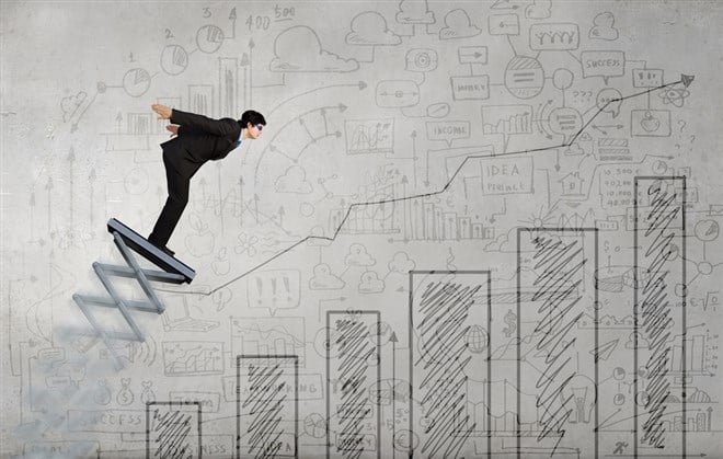 Photo of a business man on a spring board ready to jump symbolizing aggressive growth in stocks.