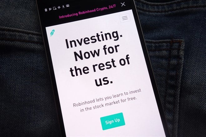 Robinhood cryptocurrency exchange website displayed on smartphone hidden in jeans pocket