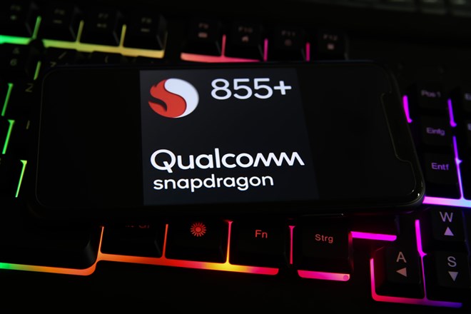 Closeup of smartphone with logo lettering of snapdragon qualcomm processor cpu on computer keyboard