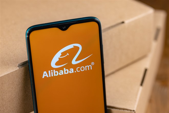 Alibaba app phone in front of boxes