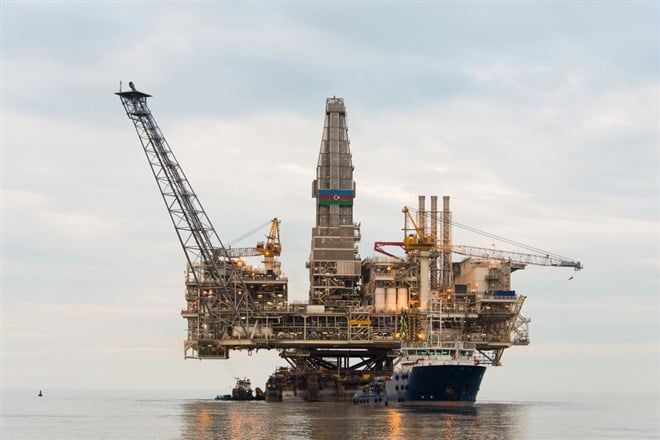 oil rig being tugged at sea