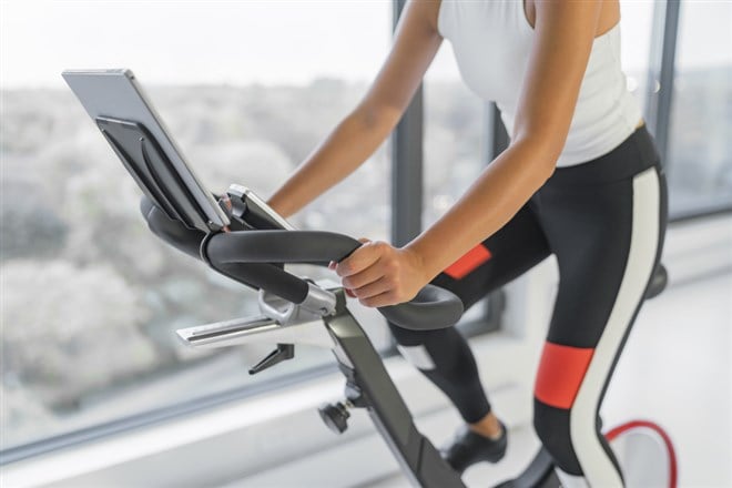 person riding exercise bike Peloton