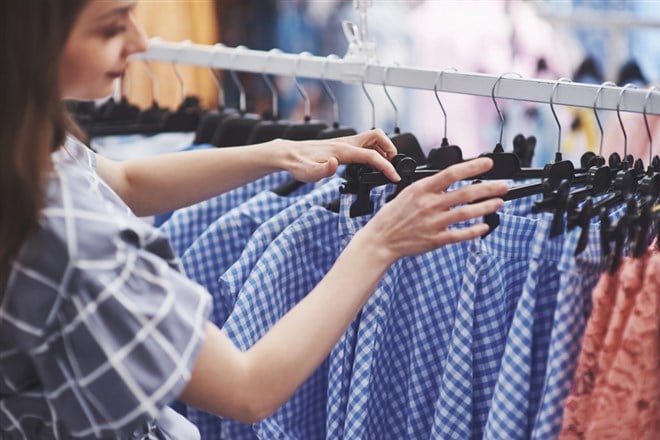 Woman shopping in retail store, close up view. - stock image