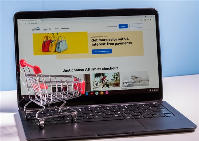 Shopping cart in front of computer screen for Affirm buy now pay later app — Stock Editorial Photography