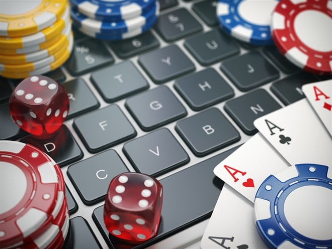 Casino online. Gambling chips , cards and dice on laptop computer background. 3d illustration