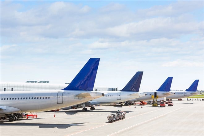 Tails of some airplanes at airport during boarding operation — Photo