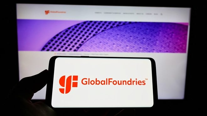 STUTTGART, GERMANY - Aug 23, 2021: Person holding cellphone with logo of US semiconductor company GlobalFoundries Inc. (GF) on screen in front of webpage. Focus on phone display. - Stock Editorial Photography