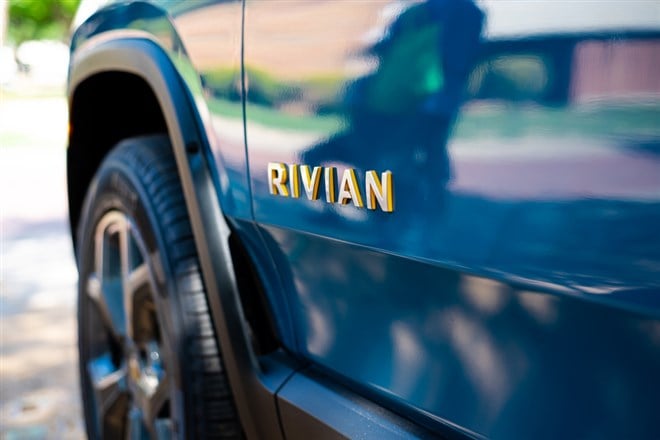 DALLAS, TX, USA-APR 22, 2023: Futuristic-looking RIVIAN branding text on driving door of brand-new electric vehicle R1T pickup truck parked outdoor. All-electric, battery-powered light duty truck